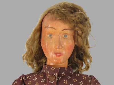 face of carved wooden folk doll