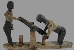 primitive wooden men on hand car